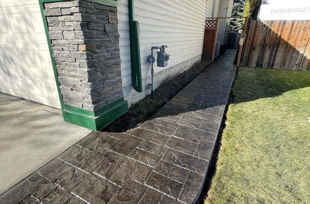 Stamped concrete next to garage on lawn